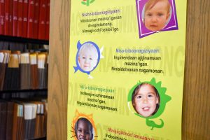 A poster in a library describing children's literacy is in Ojibwe