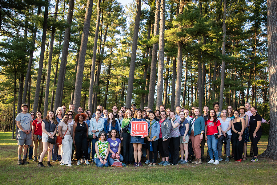 Image of people near a stand of trees.